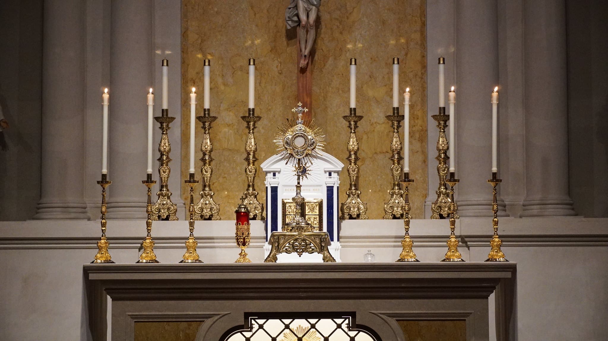 A consecrated host displayed in a golden monstrance on the altar during Eucharistic adoration