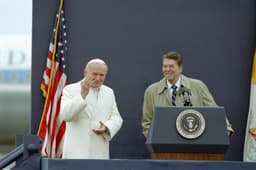 Pope John Paul II in white cassock waving beside President Ronald Reagan at Fairbanks Airport, Alaska, 1984