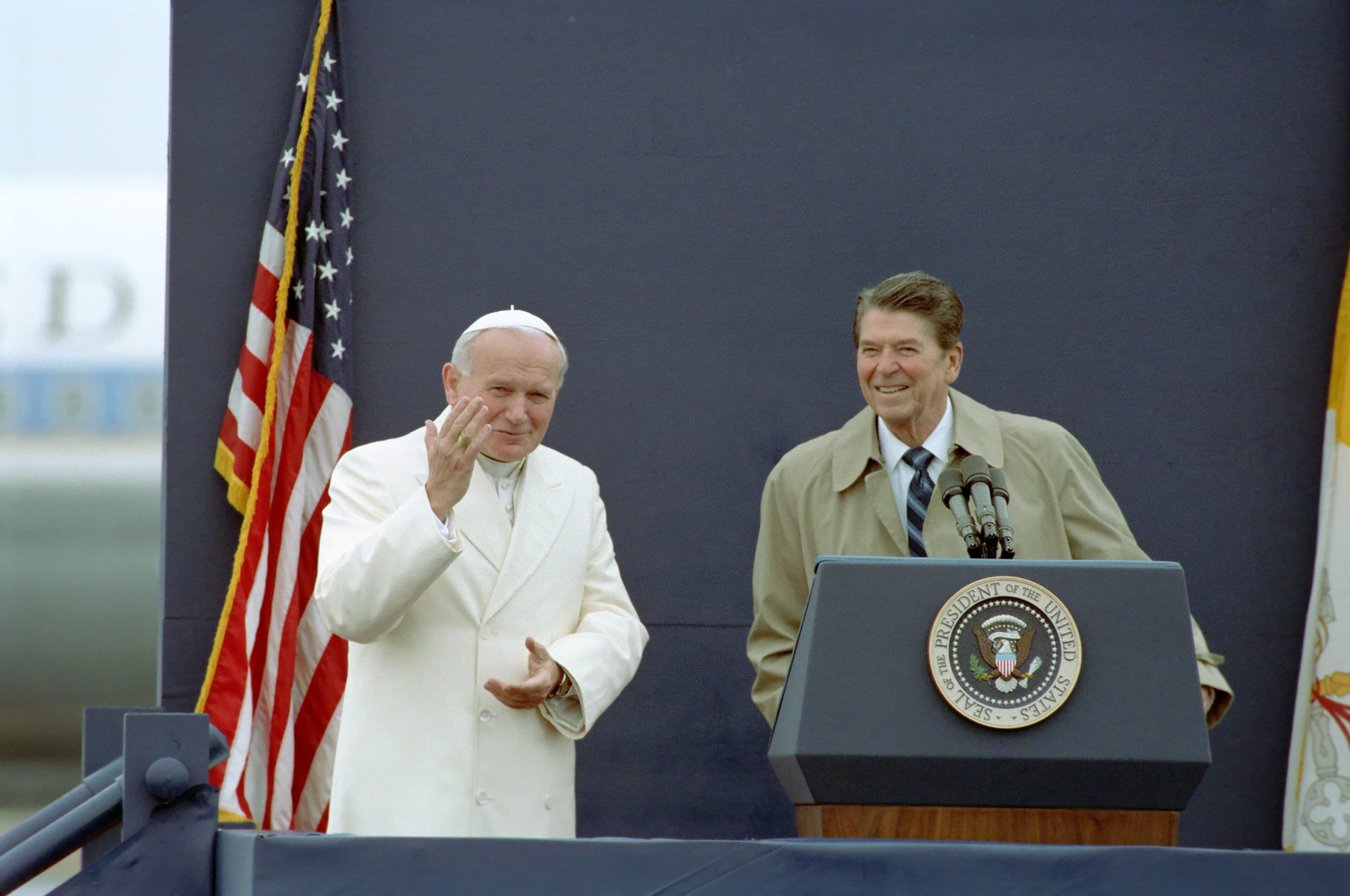 Pope John Paul II in white cassock waving beside President Ronald Reagan at Fairbanks Airport, Alaska, 1984