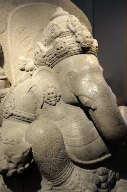 A carved stone statue of the Hindu deity Ganesha, the kind of porous-stone idol at the center of the 1995 milk-drinking phenomenon