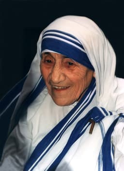 Color photograph of Mother Teresa in her white and blue sari at St Aloysius Church, Washington DC, June 1995