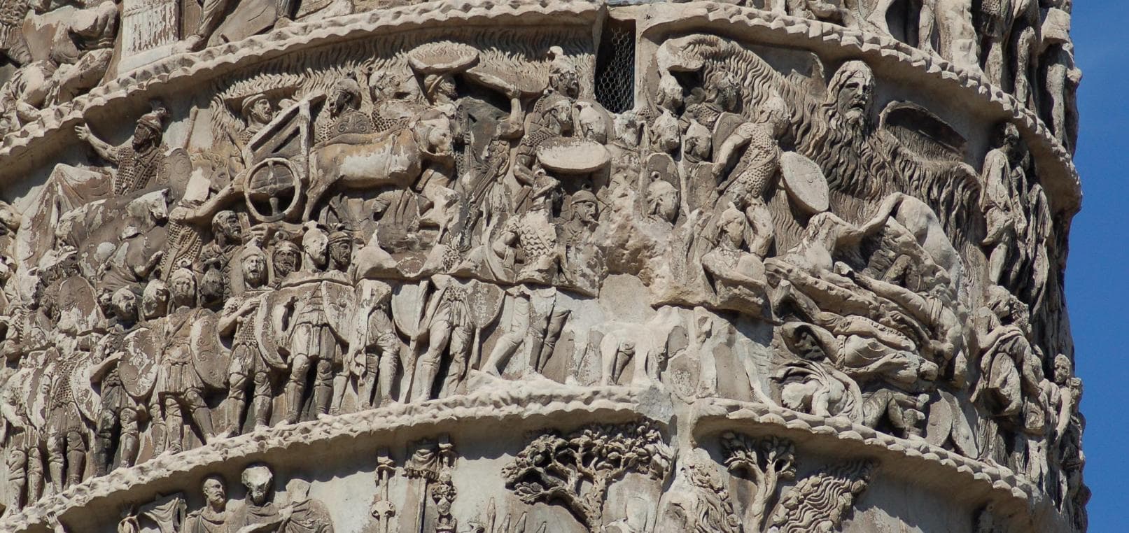 Ancient Roman marble relief on the Column of Marcus Aurelius depicting the winged rain-god with water pouring from his outstretched arms down onto Roman soldiers (the Rain Miracle, scene XVI).