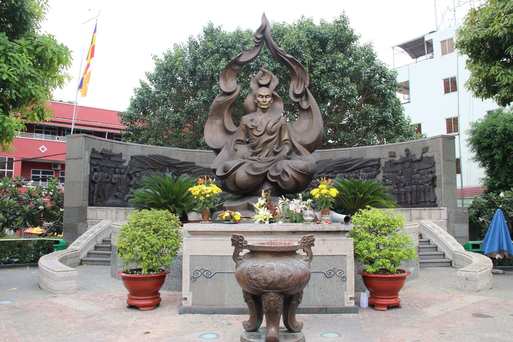 A bronze statue of the seated Buddhist monk Thich Quang Duc, part of the public memorial marking the Saigon intersection where he died in 1963.