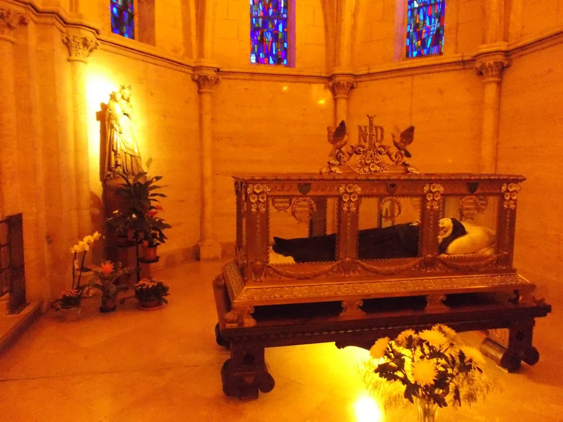 The incorrupt body of St Bernadette Soubirous lying in a glass-sided reliquary, hands clasped, in the convent chapel at Nevers, France.