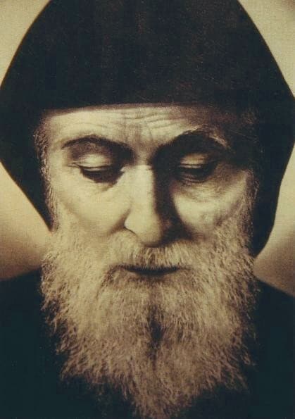 A reverent pre-1898 likeness of St Charbel Makhlouf, the bearded Lebanese Maronite monk, in his black monastic habit and hood.