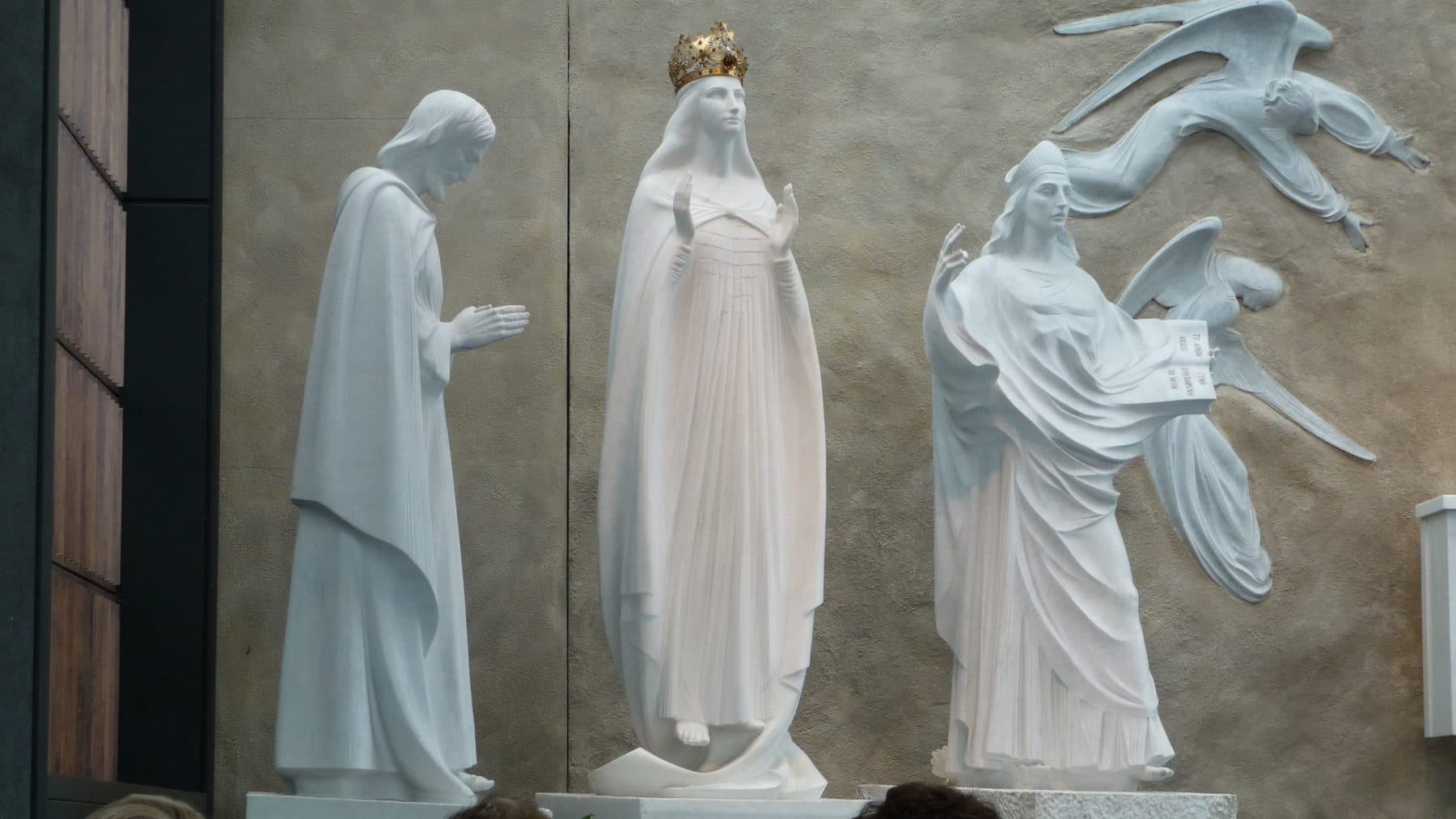 Closeup of the white marble statuary in the Apparition Chapel at Knock Shrine, County Mayo, depicting figures from the 1879 apparition.