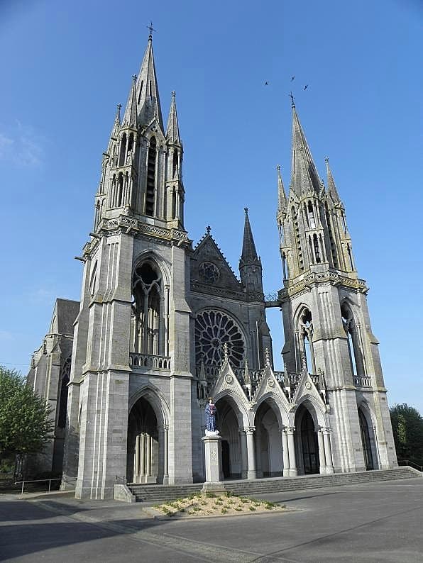 Exterior of the twin-spired neo-Gothic Basilica of Our Lady of Pontmain, Mayenne, France, built at the site of the 1871 Marian apparition.
