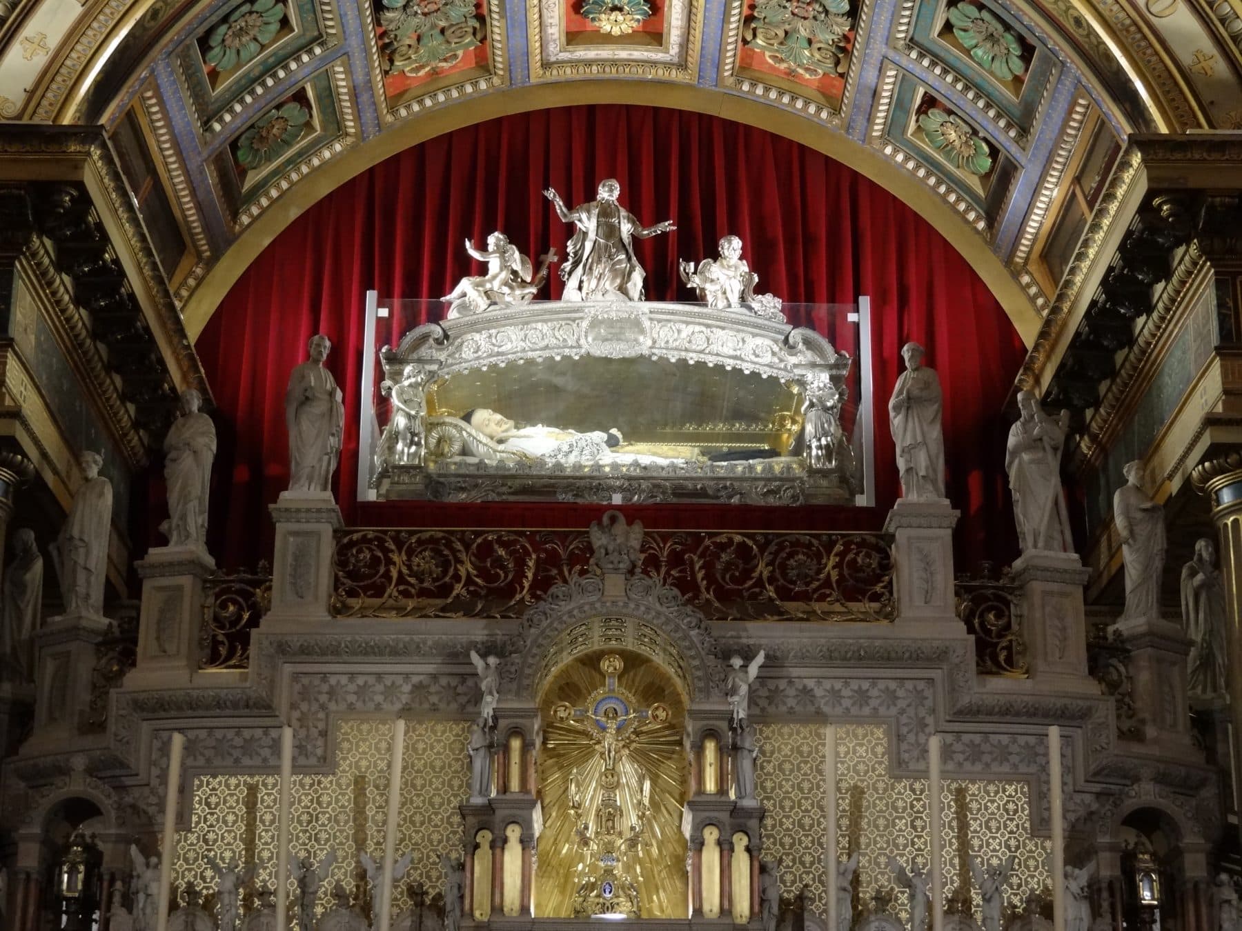 The glass-and-silver reliquary of St Vincent de Paul, holding a recumbent wax effigy over his bones, above the altar at the Chapelle Saint-Vincent-de-Paul, Paris.
